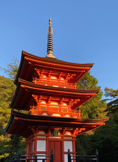 Red pagoda surrounded by trees in Japan