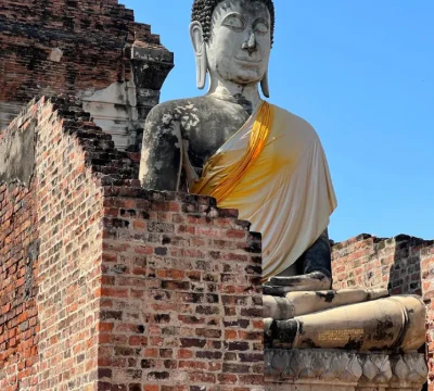 Historic Buddha among temple ruins in Thailand