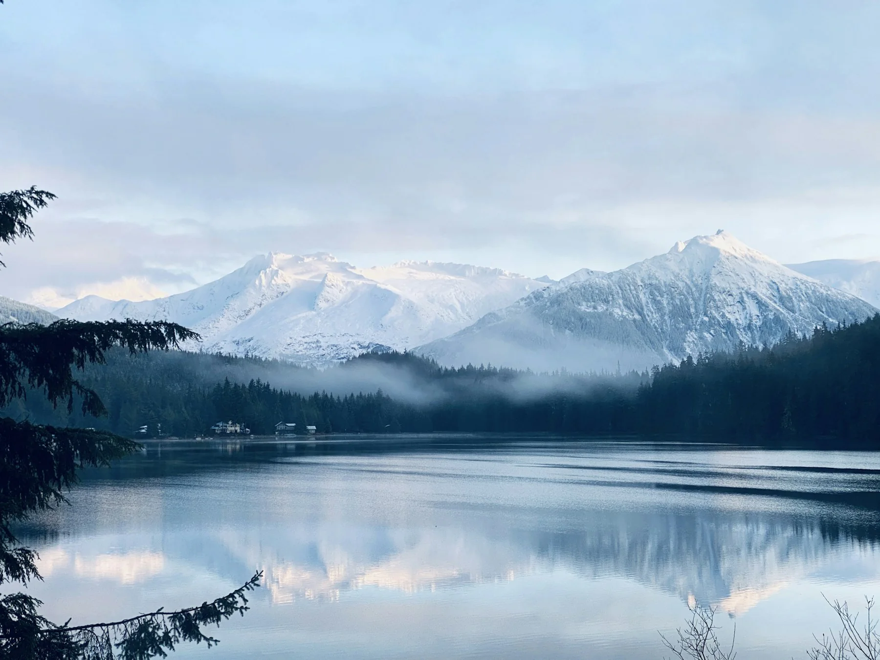 Snowy Alaskan mountains beside a clear lake
